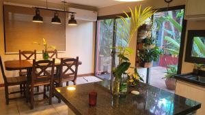 a kitchen and dining room with a dining table and a dining room at Ombú Guests House in Puerto Iguazú +5 photos