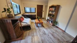 an aerial view of a living room with a couch and a table at Ombú Guests House in Puerto Iguazú