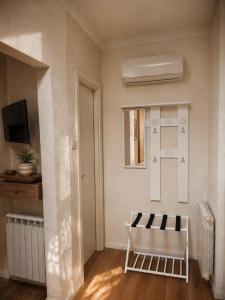 a living room with a chair and a mirror at Home Istria 81 in Trieste