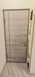 a large door in a room with a wooden floor at H apartment in Yerevan