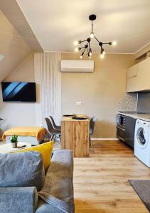 a living room with a couch and a table at Hétvezér Penthouse Apartments in Szeged