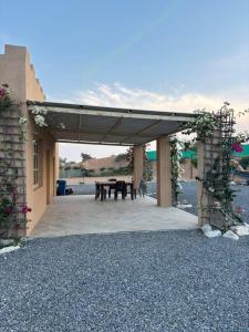 a pavilion with a picnic table in the middle at thedesert08 in Ras al Khaimah