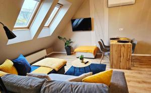 a living room with a couch and a table at Hétvezér Penthouse Apartments in Szeged