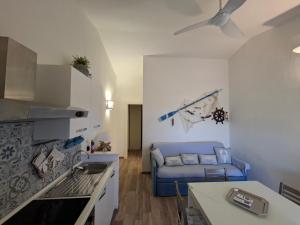 a living room with a blue couch in a kitchen at Residence Porto Rotondo in Porto Rotondo