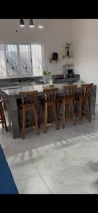 a kitchen with a table and some wooden chairs at Aldea Cardumen in Isla Aguada