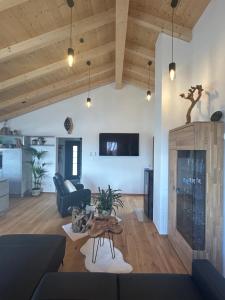 a living room with a couch and a table at Mein Haus am See in Waldkirchen