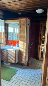 a bathroom with a sink and a toilet in a room at Hännänpää - TailTip Unique Log House in Vihti +11 photos