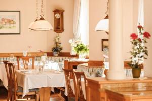 a dining room with tables and chairs and a clock at Apartment Gabriel in Melk