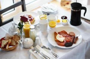 a table with a plate of breakfast foods and drinks at Donegal Manor in Donegal