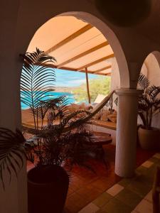 a living room with a view of the ocean at Suites Al Mar, en el malecón de San Cristóbal in San Cristóbal