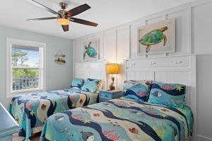 a bedroom with two beds and a ceiling fan at VitaminSeaGrove in Santa Rosa Beach +44 photos