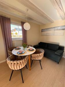 a living room with a table and a couch at Polanki 22 in Łeba