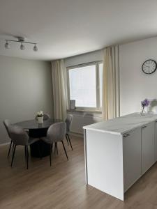 a kitchen and dining room with a table and chairs at Seminaari Hill Suite in Jyväskylä