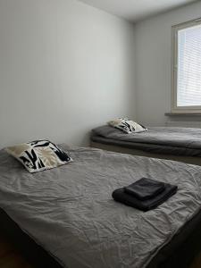 a bedroom with two beds with towels on it at Seminaari Hill Suite in Jyväskylä