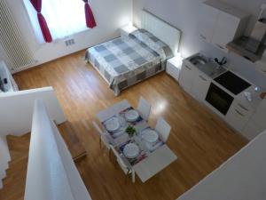 an overhead view of a room with a table and a bed at Residenza Piazza Santo Stefano in Bologna