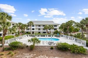 a resort with a swimming pool and palm trees at VitaminSeaGrove in Santa Rosa Beach