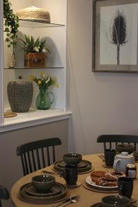 a dining room table with plates of food on it at No 3 Chapel Row in Bakewell