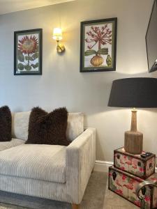 a living room with a couch and a lamp at No 3 Chapel Row in Bakewell