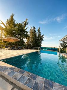 a large swimming pool with a blue at Armonia Complex in Gavalochori