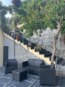 a patio with chairs and a tree and stairs at Vale Encantado in Parada de Ester