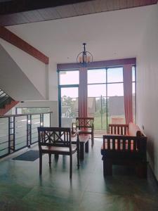 a living room with two chairs and a table at Falcon View in Nuwara Eliya