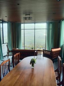 a dining room with a table and a large window at Falcon View in Nuwara Eliya +47 photos