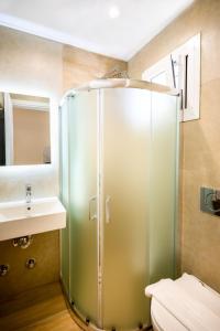 a bathroom with a shower and a sink at ML Houses Lefkada in Tsoukalades +41 photos