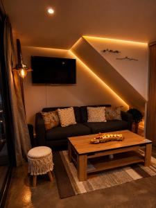 a living room with a couch and a table at Chambre d'hôte Cigale jacuzzi et jardin privé in Allauch