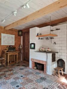 a living room with a fireplace and a table at Siedlisko Leśny Jaśmin in Łuka +24 photos