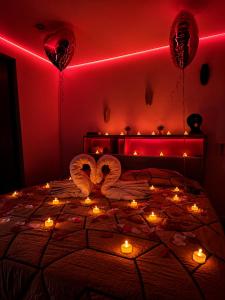 a bedroom with red lighting and hearts and candles at Chambre d'hôte Cigale jacuzzi et jardin privé in Allauch +24 photos