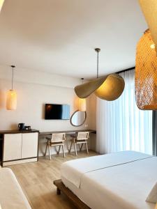 a hotel room with a bed and a tv at Alex & Sofi Hotel in Himare