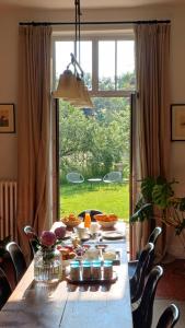a table with food on it in front of a large window at Le Manivert in Vitry-Laché
