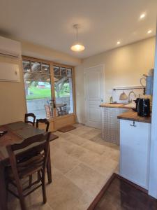 a kitchen and dining room with a table and chairs at La Ferme de Jeanne in Francescas