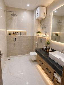 a bathroom with a sink and a toilet and a mirror at Hotel CIELO PRIME Near Delhi Airport in New Delhi +30 photos
