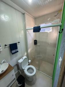 a bathroom with a shower and a toilet and a sink at Casa Container Completa e Privativa em Sombrio-SC in Sombrio