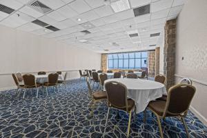 a room with tables and chairs in a room at The Barclay Towers Hotel and Resort in Virginia Beach +34 photos