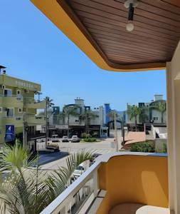 a balcony with a view of a parking lot at Pousada Acapulco in Bombinhas