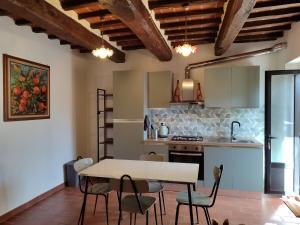 a kitchen and dining room with a table and chairs at B&B Casa Fattorini in Cortona