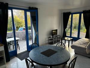 a living room with a table and a couch at Hôtel Les Persèdes in Lavilledieu +95 photos