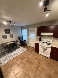 a kitchen with a stove and a table in it at #HycheHoops Final Four Nest in Starkville