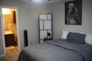 a bedroom with a bed and a picture on the wall at #HycheHoops Final Four Nest in Starkville