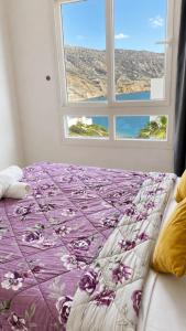 a bed in a room with a window at Padova Surf Hous in Imsouane