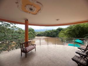 a balcony with chairs and a view of a pool at Hotel Cristalina in Melgar