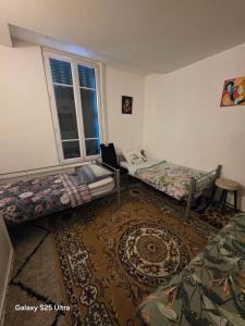 a room with two bunk beds and a rug at PR001 3 chambres in Le Blanc-Mesnil