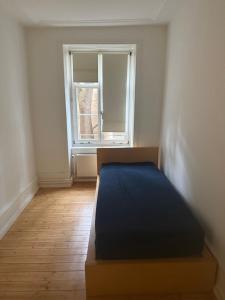 an empty room with a bed and a window at Basel Shared Apartment in Basel