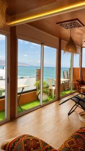 a living room with a view of the ocean at Padova Surf Hous in Imsouane