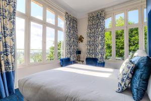 a bedroom with a large bed and windows at Domaine De La Corniche in Rolleboise +162 photos
