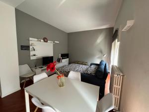 a bedroom with a bed and a table and a desk at Maison de l'Eau by Lago Maggiore Rentals in Verbania
