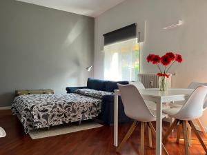 a living room with a table and a blue couch at Maison de l'Eau by Lago Maggiore Rentals in Verbania