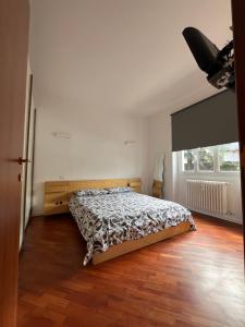 a bedroom with a bed and a wooden floor at Maison de l'Eau by Lago Maggiore Rentals in Verbania